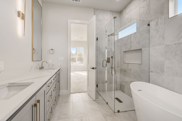 bathroom featuring independent shower and bath, tile patterned floors, double sink vanity, and plenty of natural light