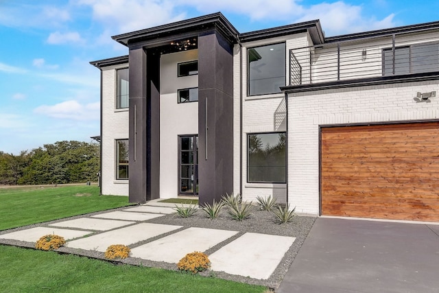 exterior space featuring a garage and a lawn