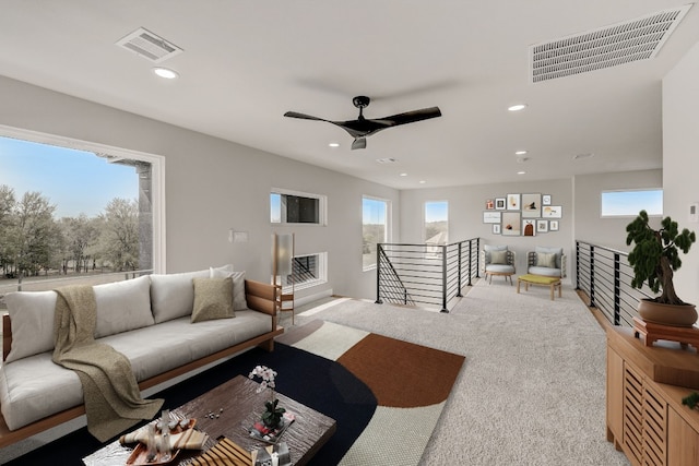 carpeted living room featuring ceiling fan