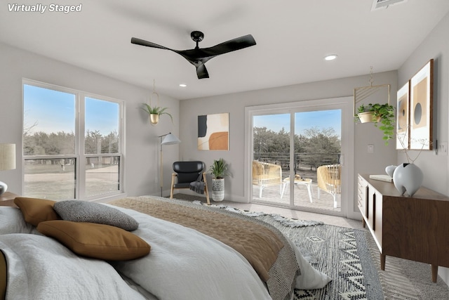 bedroom featuring carpet floors, access to exterior, multiple windows, and ceiling fan