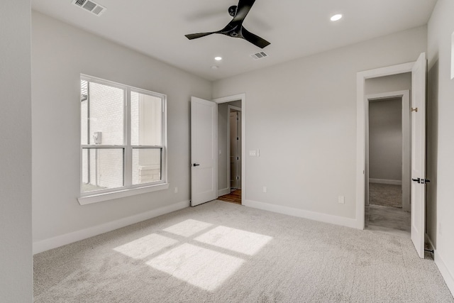 unfurnished bedroom with light carpet and ceiling fan