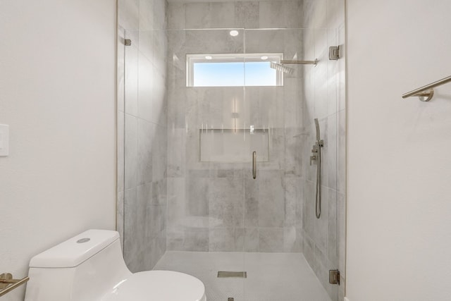 bathroom featuring toilet and an enclosed shower