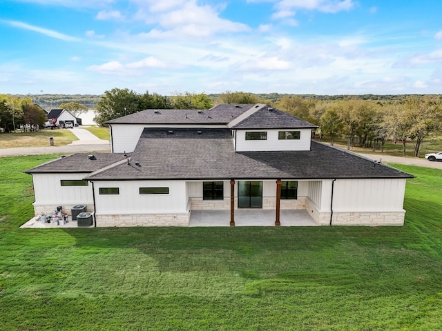 rear view of property with a patio and a yard