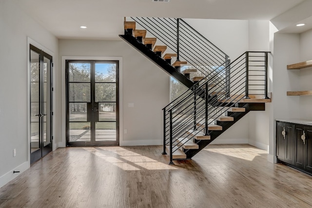 foyer featuring french doors and light wood-type flooring