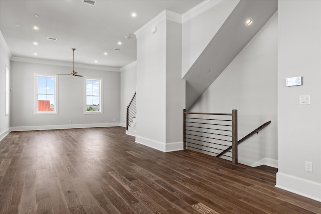 unfurnished living room featuring crown molding, ceiling fan, and dark wood-type flooring