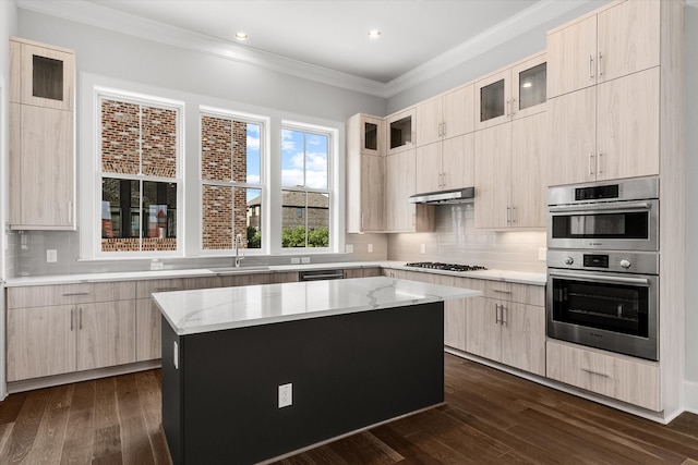 kitchen with a kitchen island, dark hardwood / wood-style floors, and gas cooktop