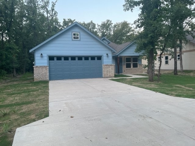 view of front of home with a front yard and a garage