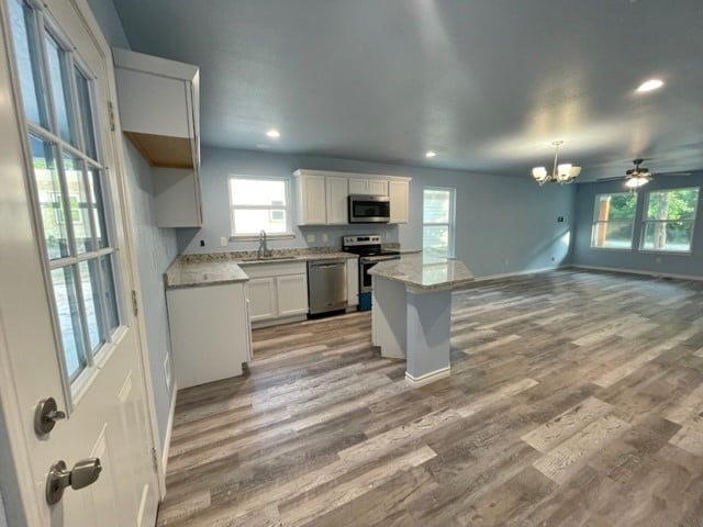 kitchen featuring white cabinets, light hardwood / wood-style flooring, appliances with stainless steel finishes, and sink