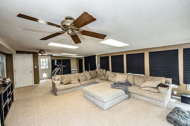 living room featuring ceiling fan and a textured ceiling