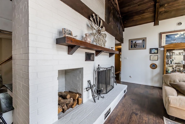 living room featuring hardwood / wood-style flooring, vaulted ceiling with beams, wooden ceiling, and a fireplace