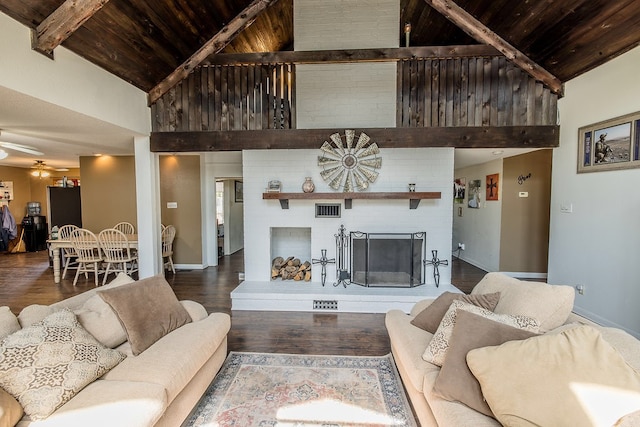 living room with wood ceiling, ceiling fan, beam ceiling, hardwood / wood-style flooring, and a fireplace