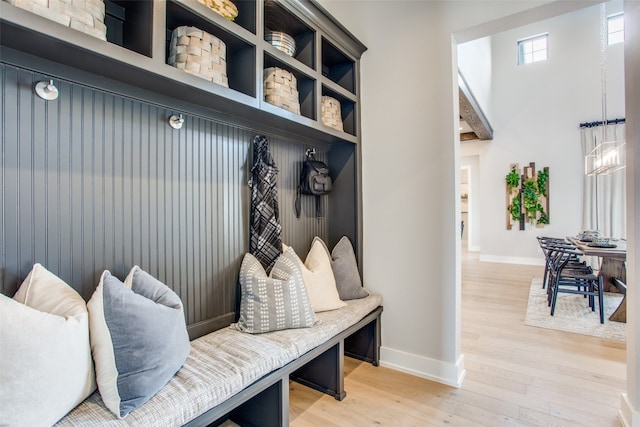 mudroom featuring light hardwood / wood-style floors and a notable chandelier