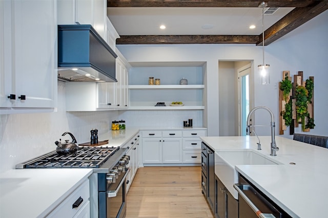 kitchen with white cabinetry, light wood-type flooring, stainless steel appliances, and pendant lighting