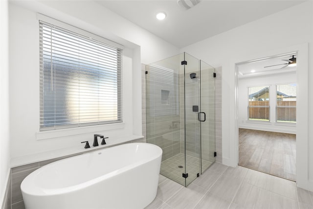 bathroom featuring tile patterned flooring, shower with separate bathtub, and ceiling fan