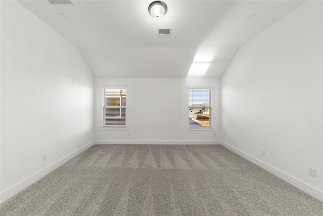 bonus room with plenty of natural light, carpet, and lofted ceiling