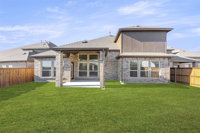 rear view of property featuring a patio and a yard