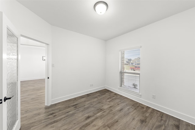 spare room with wood-type flooring