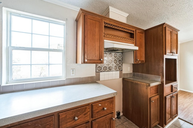 kitchen with decorative backsplash and a textured ceiling