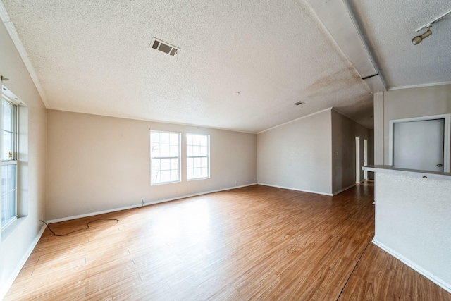 unfurnished living room with hardwood / wood-style floors and a textured ceiling