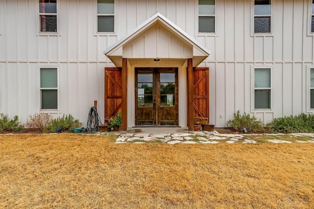 entrance to property with french doors and a yard