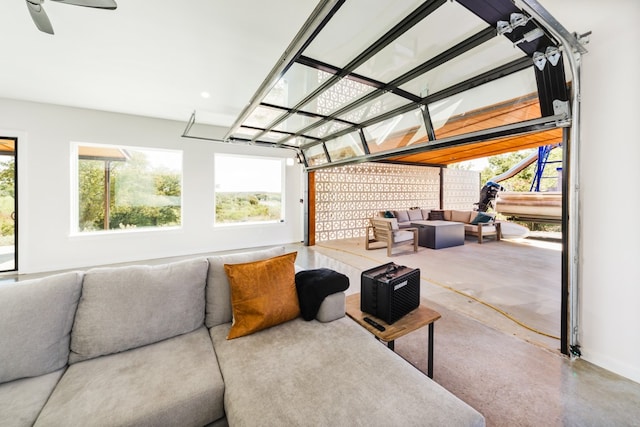 living room with concrete floors and ceiling fan