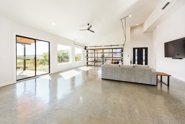 unfurnished living room with concrete floors and ceiling fan