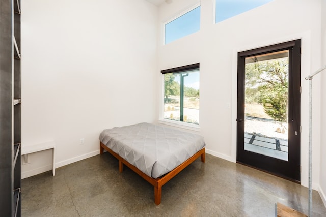 bedroom with access to outside and a towering ceiling