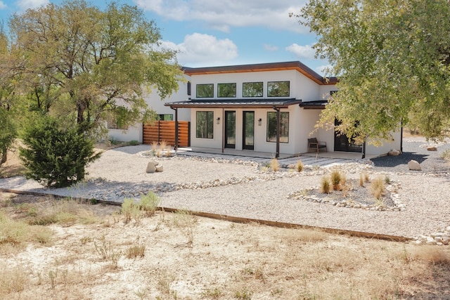 rear view of property with a patio area and french doors