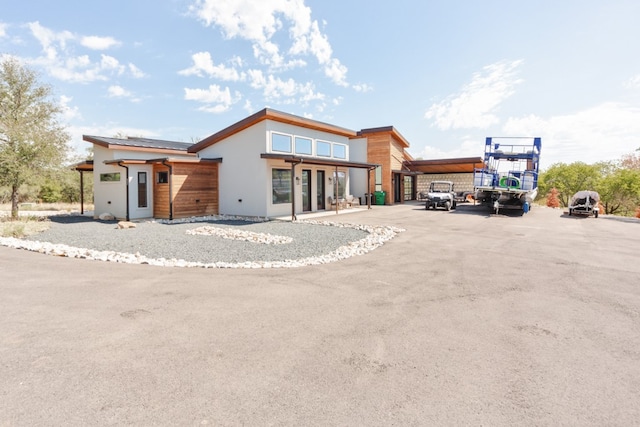 contemporary house featuring a carport