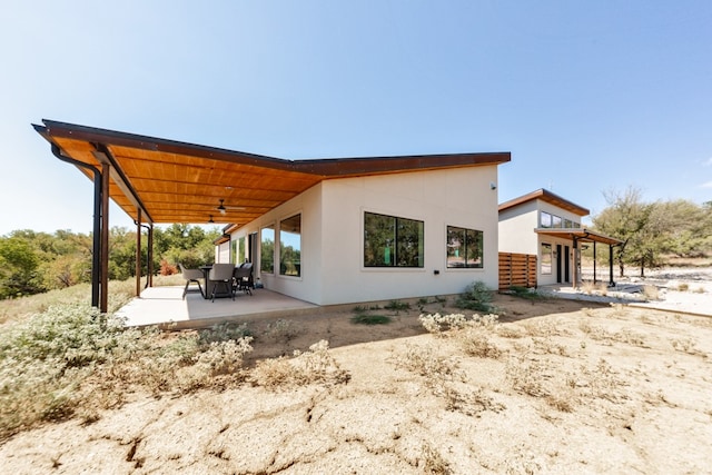 back of house with a patio and ceiling fan