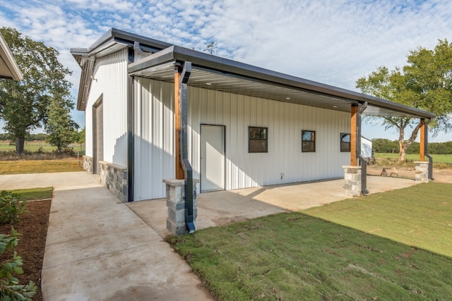 back of house with a yard and a patio