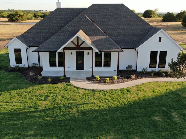 view of front facade with a front yard and a patio