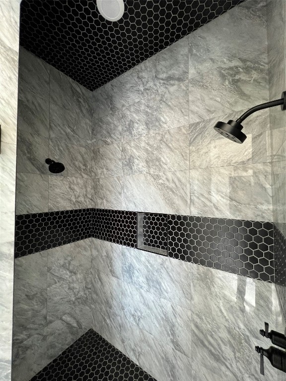 bathroom with a tile shower