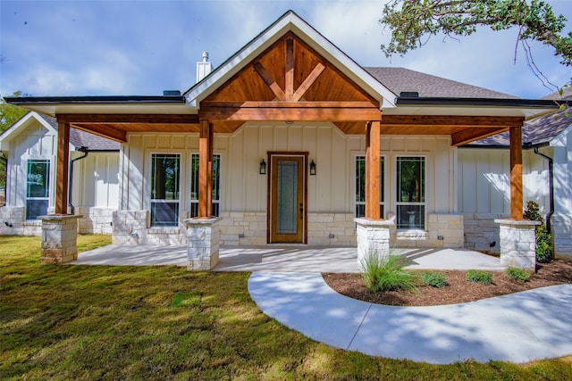 view of front of property with a front yard and a porch