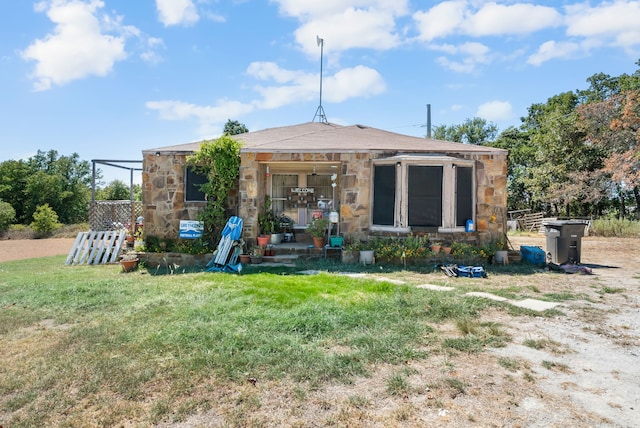 rear view of house with a yard