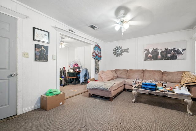 living room with ornamental molding, ceiling fan, and carpet floors