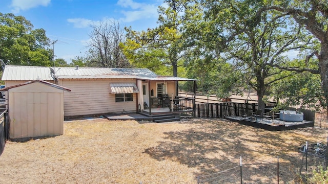 back of property featuring a storage shed