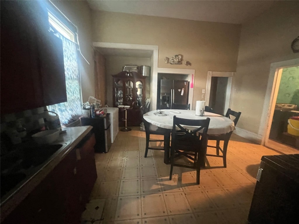 dining area featuring light tile flooring