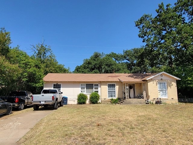 ranch-style home with a front lawn