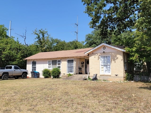 ranch-style home with a front lawn