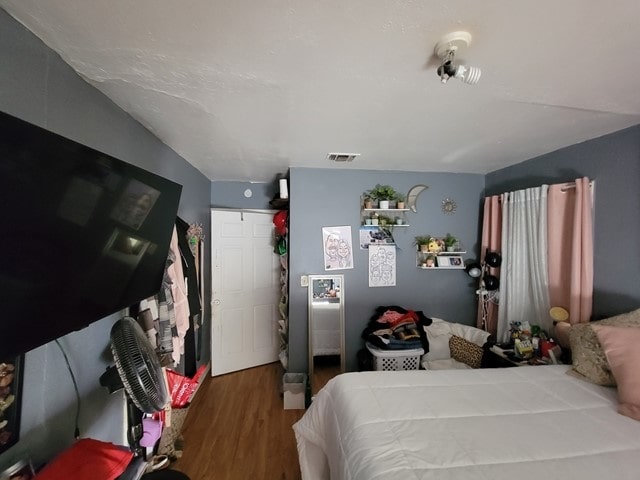 bedroom with hardwood / wood-style floors