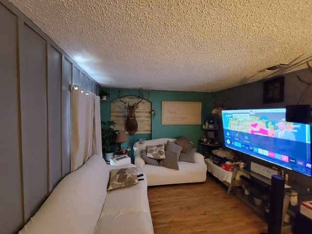 living room featuring hardwood / wood-style floors and a textured ceiling