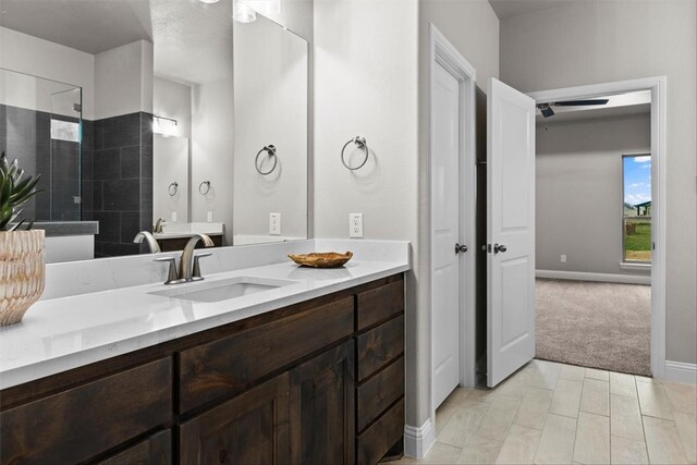 bathroom with hardwood / wood-style floors, vanity, and walk in shower