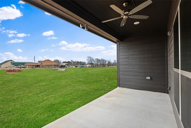 view of yard featuring ceiling fan and a patio area