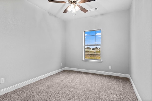 carpeted spare room with ceiling fan