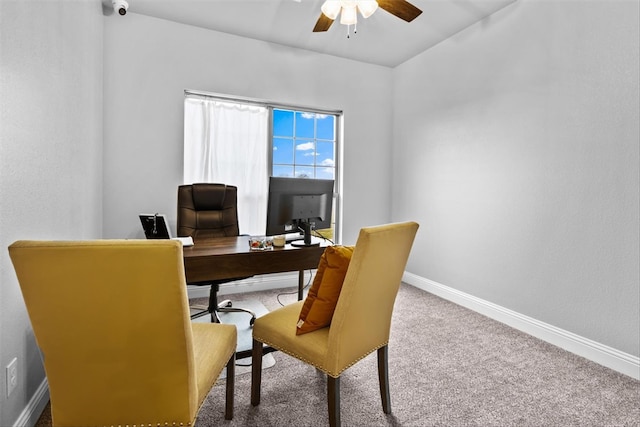 carpeted office space with ceiling fan