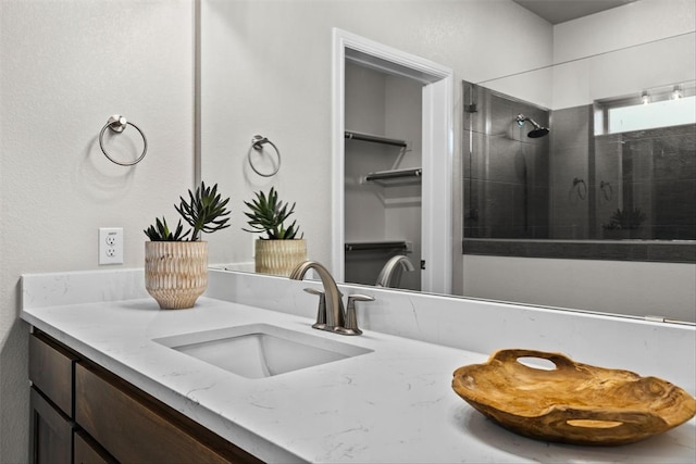 bathroom featuring vanity and a shower with door