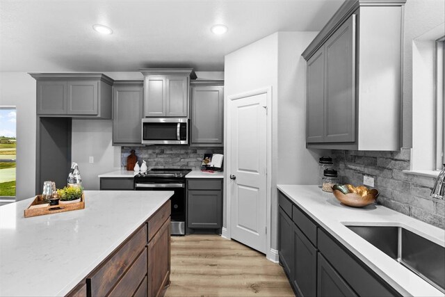 clothes washing area with light wood-type flooring and electric dryer hookup