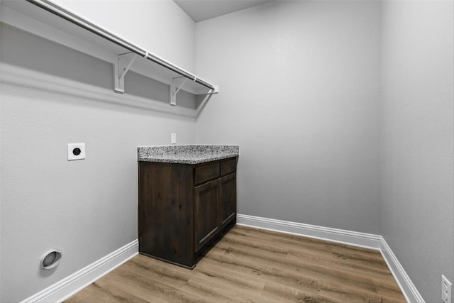 laundry area with light hardwood / wood-style floors and electric dryer hookup