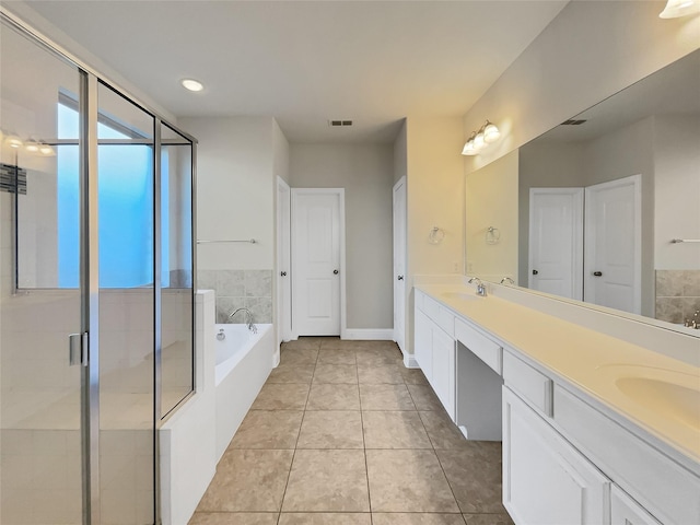 bathroom with tile patterned flooring, vanity, and separate shower and tub